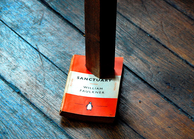 Table leg with book wedged under it