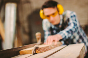 Man cutting wood with saw blade