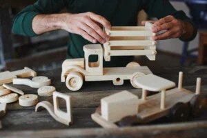 man building wooden toys