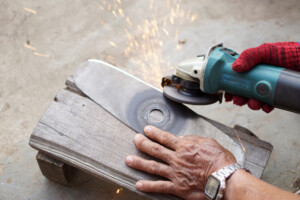 man using multi tool saw for cutting metal