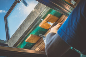 person cutting wood using a reciprocating saw